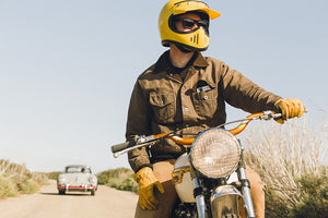 Model on Triumph Bonneville, wearing the khaki Iron and Resin biker jacket.