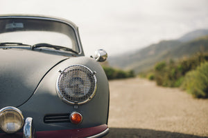 Porsche 356 911 against mountainous landscape.